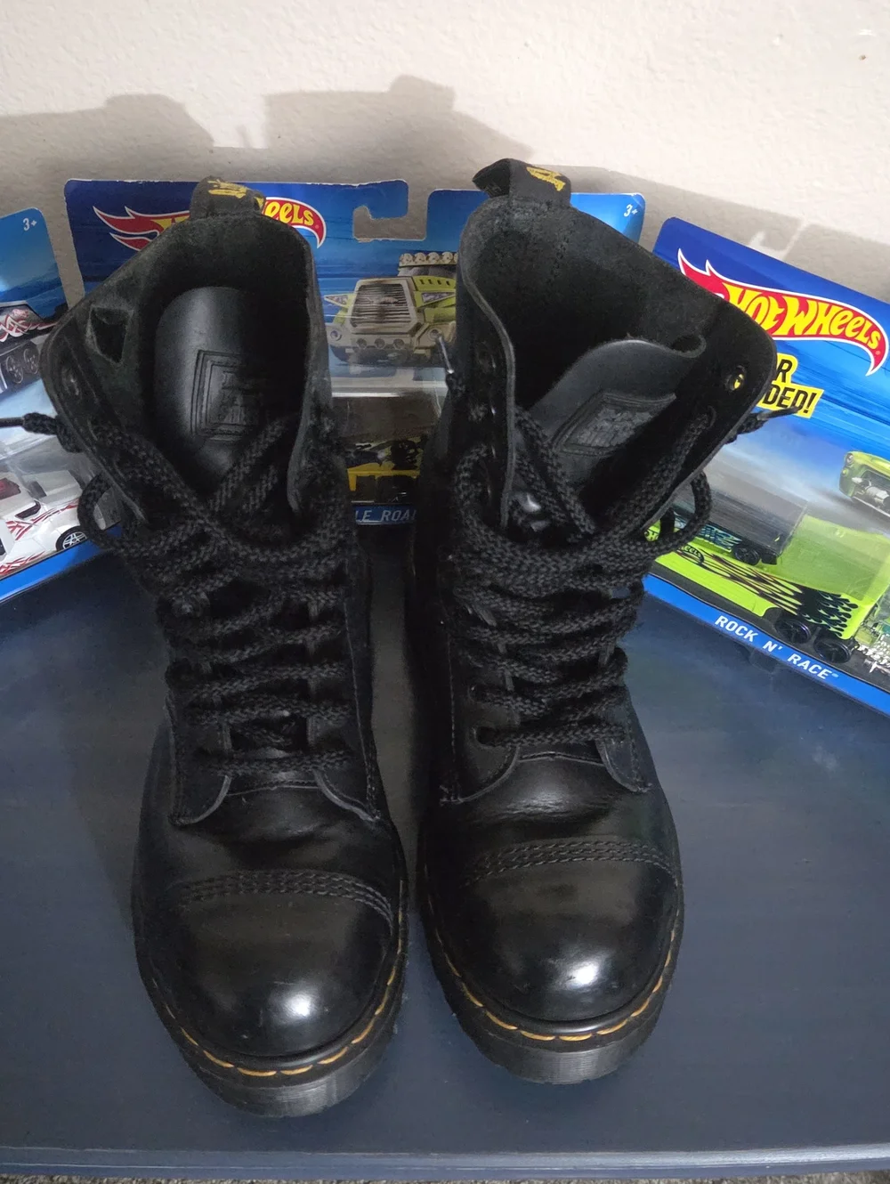 Dr. Martens steel toe black leather lace-up combat boots.
